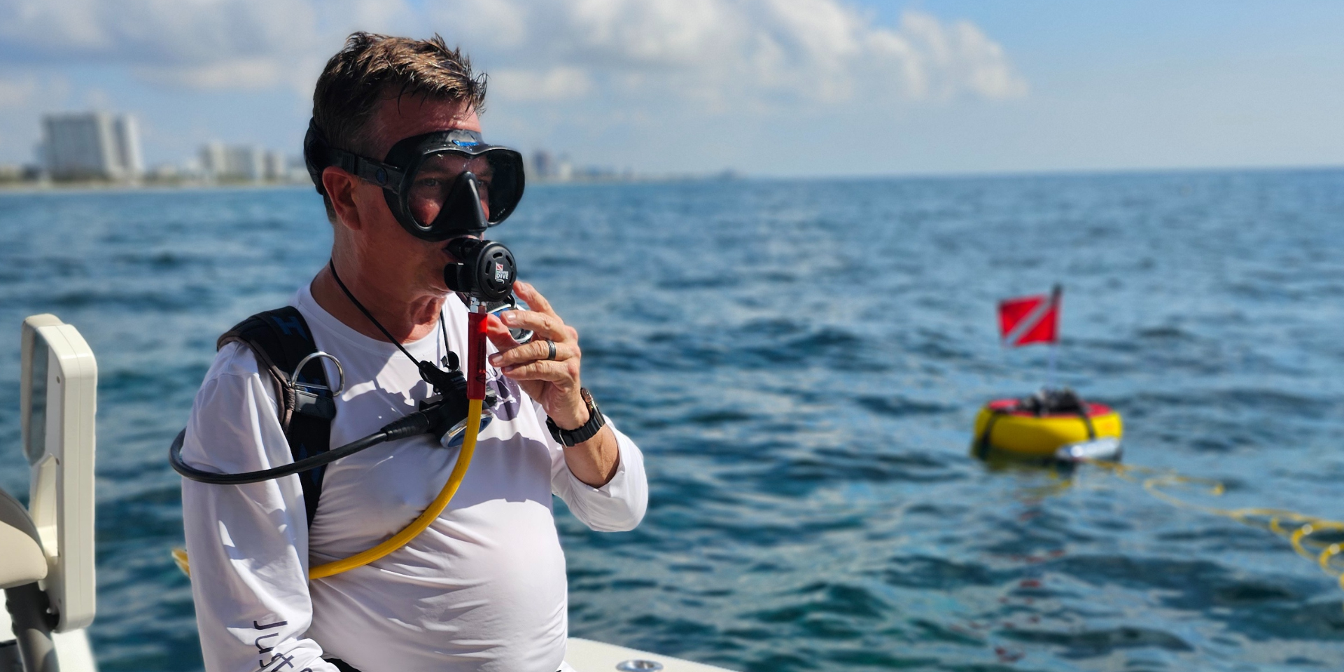 diver-getting-ready-with-sealion-dive-system Diver getting ready with the Sea Lion tankless scuba system on a boat.