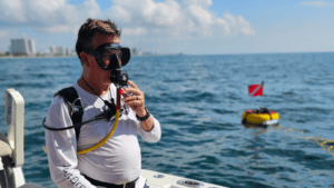 Diver getting ready with the Sea Lion tankless scuba system on a boat.