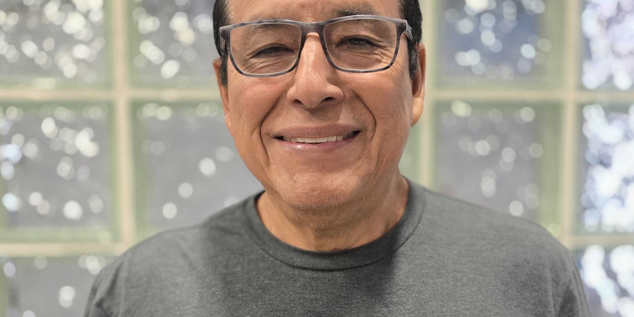 Alejandro, Machinist at Brownie's THIRD LUNG, smiling in a gray Brownie's branded shirt.
