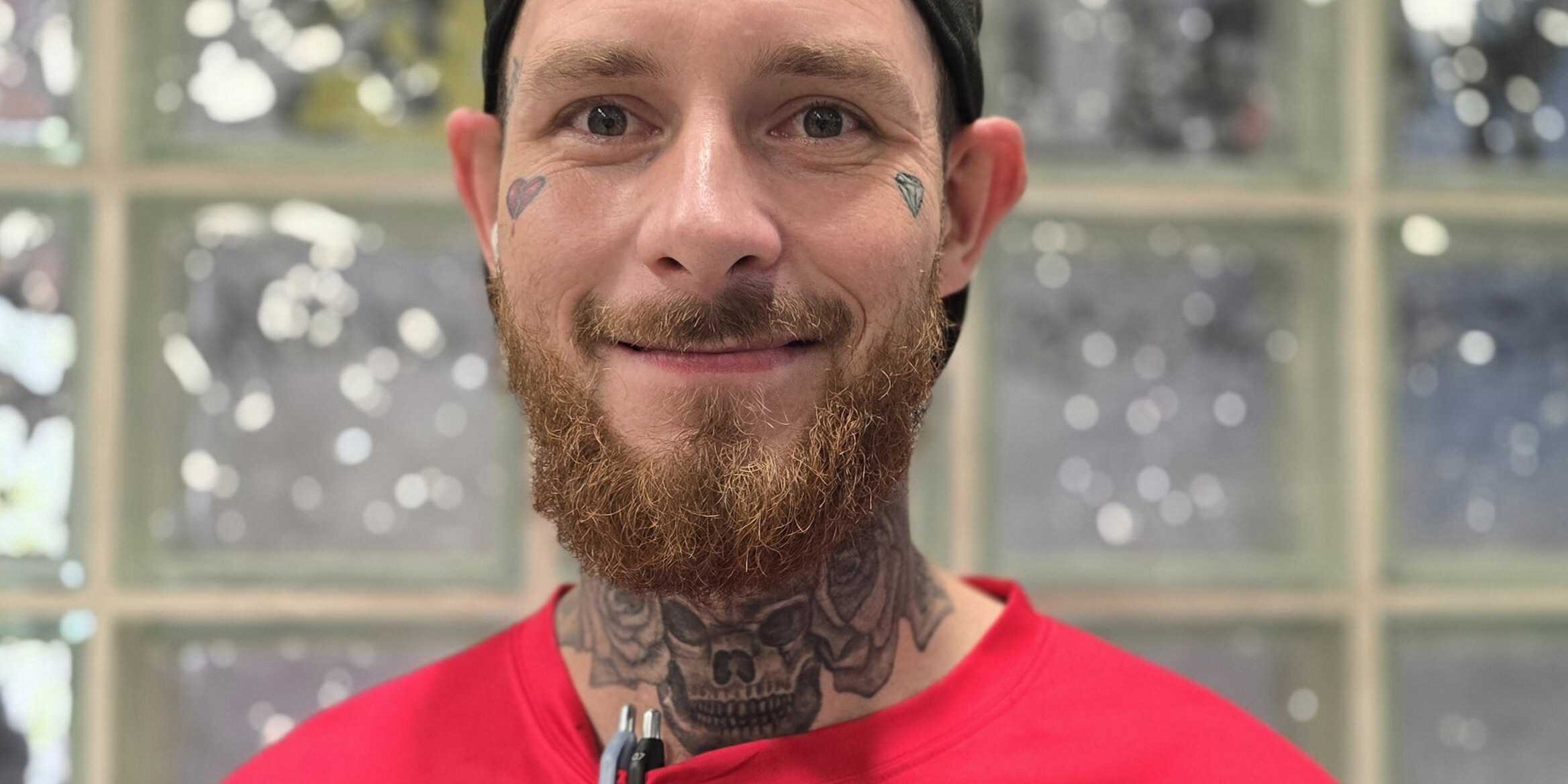 Michael, Mechanic and Service Specialist at Brownie's THIRD LUNG, smiling in a red Brownie's branded shirt.