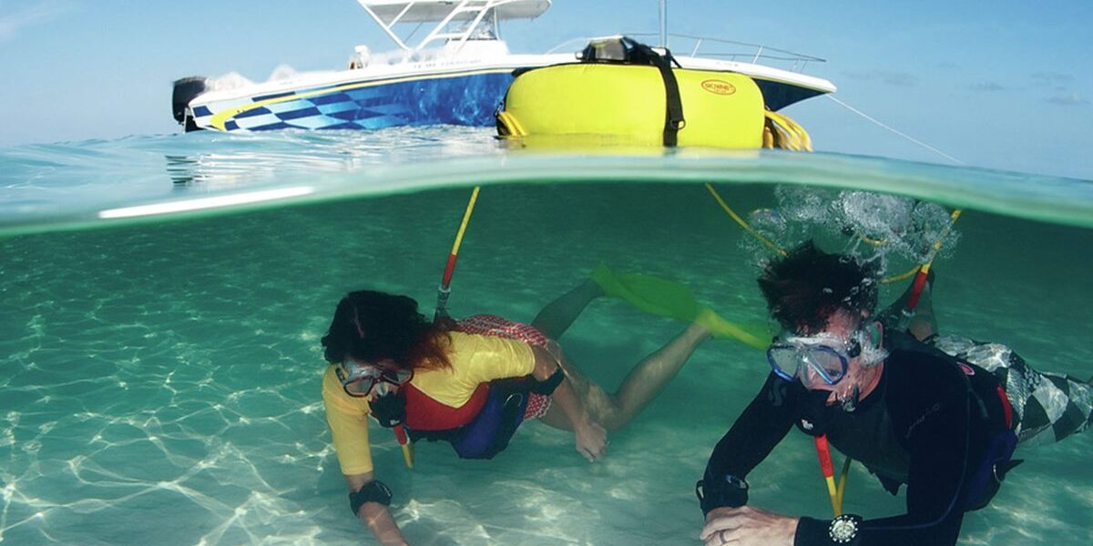 Divers underwater breathing from a Brownie's Third Lung surface supplied air dive system